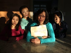 Carolyn Chin is unhappy about the limited grading scale on report cards. She is pictured at her home in Calgary, Alta., on Friday January 13, 2017, with her children Sophie Knapik, 10, left, Ben Knapik, 14, and SamKnapik, 12. Leah Hennel/Postmedia