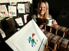 Erin Moffatt, a laid off oil and gas engineer turned entrepreneur at her home in Calgary, Alta., on Thursday January 19, 2017, sells clothing, cards, etc., from her home-based business called Poop Heart Inc. and has specifically chosen to ship straight from her Calgary-based manufacturer to keep traffic down at her house. Leah Hennel/Postmedia