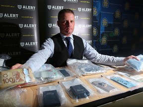 Staff Sgt. Keith Hurley with items seized in ALERT’s largest fentanyl seizures in Calgary on Thursday, Jan. 19, 2017.