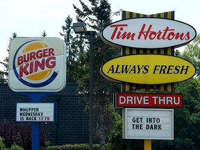 A Burger King sign and a Tim Hortons sign in Ottawa.