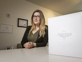 Kala Ortwein poses for a photo with her thesis 'My Father the Homeless Guy' inside her home in Calgary, Alta., on Saturday, Feb. 4, 2017. Ortwein, who was 17 when her father began living on the streets, recently finished a thesis that studies her experience and those of other daughters of homeless dads. Lyle Aspinall/Postmedia Network