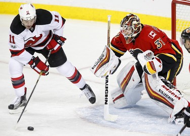 New Jersey Devils PA Parenteau, left, takes a shot Calgary Flames goalie Chad Johnson in NHL hockey action at the Scotiabank Saddledome in Calgary, Alta. on Friday January 13, 2017. Leah Hennel/Postmedia