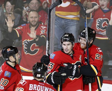 Calgary Flames Sean Monahan, left, celebrates his goal on New Jersey Devils with Dougie Hamilton, right, in NHL hockey action at the Scotiabank Saddledome in Calgary, Alta., on Friday January 13, 2017. Leah Hennel/Postmedia