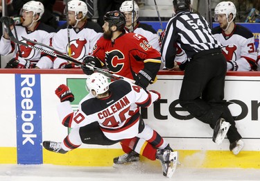 New Jersey Devils Blake Coleman, left, collides with Calgary Flames Deryk Engelland in NHL hockey action at the Scotiabank Saddledome in Calgary, Alta. on Friday January 13, 2017. Leah Hennel/Postmedia