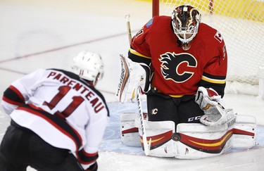 Calgary Flames goalie Chad Johnson stops a shot on net from New Jersey Devils PA Parenteau in NHL hockey action at the Scotiabank Saddledome in Calgary, Alta., on Friday January 13, 2017. Leah Hennel/Postmedia