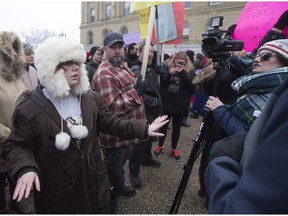 A participant in the Women's March steps in to try and calm the scene after The Rebel TV reporter Sheila Gunn Reid (right) was allegedly assaulted by a man, in Edmonton, Alta., on Saturday January 21, 2016. Edmonton police are investigating the incident.