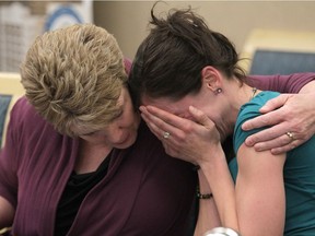 A tearful Jen Ward cries and is comforted as she resigns as  a Calgary Police Service officer in Calgary, Alta on Tuesday January 31, 2017.