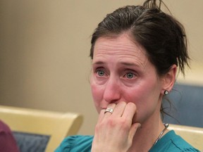 A tearful Const. Jen Ward cries as she resigns from the Calgary Police Service on Jan. 31.