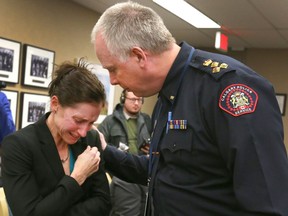 A tearful Jen Ward cries and is comforted by Police Chief Roger Chaffin after she resigned her position of a Calgary Police Service officer in Calgary, Alta on Tuesday January 31, 2017. Ward stood in front of the police commission and cited bullying and harassment as the reasons for her resigning her position. Her husband continues as a member of the police force.