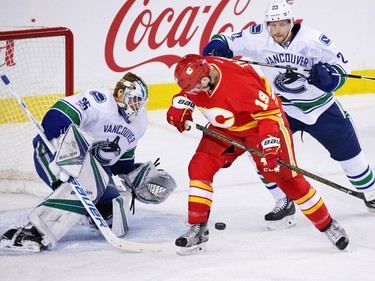 The Calgary Flames' Matthew Tkachuk looks for the loose puck in front of Vancouver Canucks goaltender Jacob Markstrom during NHL action at the Scotiabank Saddledome in Calgary on Saturday January 7, 2017.