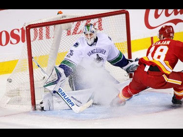 The Calgary Flames' Matt Stajan scores on Vancouver Canucks goaltender Jacob Markstrom during NHL action at the Scotiabank Saddledome in Calgary on Saturday January 7, 2017.