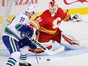Calgary Flames goaltender Chad Johnson stops this scoring chance by the Vancouver Canucks' Henrik Sedin during NHL action at the Scotiabank Saddledome in Calgary on Saturday January 7, 2017.