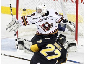 Brandon Wheat Kings' Reid Duke, scores one of his four goals Sunday on Calgary Hitmen goalie Trevor Martin at the Scotiabank Saddledome. (Leah Hennel)