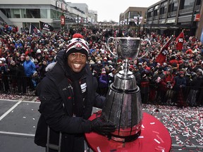 Ottawa Redblacks quarterback Henry Burris touches the Grey Cup following a rally celebrating the team's victory over the Calgary Stampeders in November.