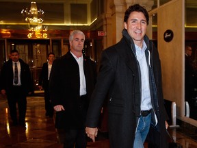 Prime Minister Justin Trudeau, right, arrives at a Liberal cabinet retreat in Calgary on Sunday, Jan. 22, 2017.