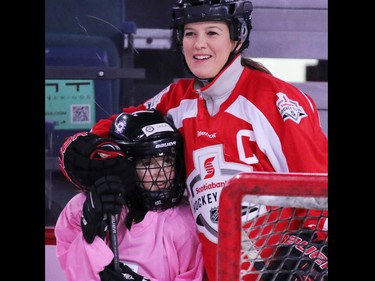 Olympic gold medalist Cassie Campbell-Pascall gives a player a little hug as she helps coach novice level girls in the Scotiabank Girls HockeyFest at the Saddledome in Calgary on Sunday January 8, 2017.