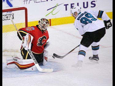 The Calgary Flames Chad Johnson stops this penalty shot by the San Jose Sharks' Mikkel Boedker during NHL action at the Scotiabank Saddledome in Calgary on Wednesday January 11, 2017.
