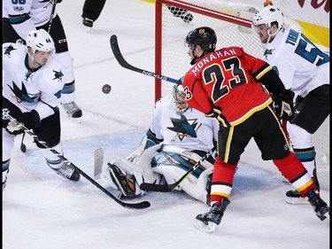 The Calgary Flames' Sean Monahan reaches out to grab this rebounding puck in front of San Jose Sharks goaltender Aaron Dell during NHL action at the Scotiabank Saddledome in Calgary on Wednesday January 11, 2017. The Flames won the game 3-2.