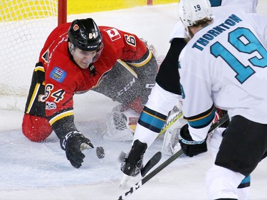 The Calgary Flames' Garnet Hathaway reaches out to stop the puck during a San Jose Sharks scoring chance in a wild play during NHL action at the Scotiabank Saddledome in Calgary on Wednesday January 11, 2017.