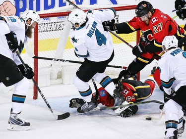 The Calgary Flames' Garnet Hathaway on the ice and Dougie Hamilton scramble to stop this San Jose Sharks scoring chance in a wild play during NHL action at the Scotiabank Saddledome in Calgary on Wednesday January 11, 2017.