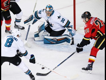 The Calgary Flames' Sean Monahan reaches out to grab this rebounding puck in front of San Jose Sharks goaltender Aaron Dell during NHL action at the Scotiabank Saddledome in Calgary on Wednesday January 11, 2017.