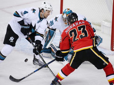 The Calgary Flames' Sean Monahan reaches out to grab this rebounding puck in front of San Jose Sharks goaltender Aaron Dell during NHL action at the Scotiabank Saddledome in Calgary on Wednesday January 11, 2017.