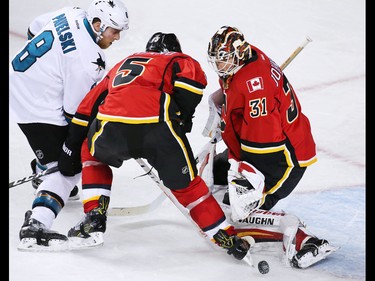 The Calgary Flames Mark Giordano and goaltender Chad Johnson stop this San Jose Sharks scoring chance by Joe Pavelski during NHL action at the Scotiabank Saddledome in Calgary on Wednesday January 11, 2017.