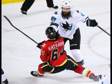 San Jose Sharks defenceman Brent Burns shoves Calgary Flames forward Garnet Hathaway during NHL action at the Scotiabank Saddledome in Calgary on Jan. 11, 2017.