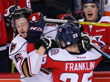 Calgary Hitmen Andrew Fyten and the Lethbridge Hurricanes' Zane Franklin collide during WHL action at the Scotiabank Saddledome on Sunday January 15, 2017.