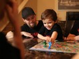 Journey Dickson, 6, plays a board game with his family including dad Doug on Sunday January 15, 2017. Both Doug and Journey suffer from a rare blood disorder that requires many hospital and other medical trips a month. The struggling family has started a GoFundMe campaign to raise money for a new vehicle. GAVIN YOUNG/POSTMEDIA