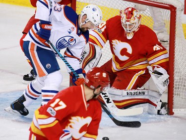 Edmonton Oilers forward Matt Hendricks, playing his 500th NHL game, tries to get the puck past Calgary Flames goaltender Chad Johnson at the Scotiabank Saddledome in Calgary on Saturday January 21, 2017.