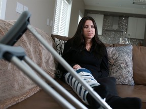 West Springs resident Cheryl Gunja is concerned that the City is not clearing an icy pathway near her daughter's school. Gunja slipped and broke her knee cap on the pathway this past week. She was photographed at her home on Sunday January 22, 2017.  GAVIN YOUNG/POSTMEDIA