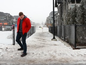 West Springs resident Robert Gunja walks on an icy connecting pathway near his daughter's school on Sunday January 22, 2017. This past week Robert's wife Cheryl slipped and broke her knee cap on the ice.