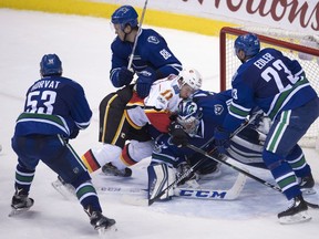 Calgary Flames centre Mikael Backlund (11) tries to get a shot past Vancouver Canucks goalie Ryan Miller (30) during third period NHL action in Vancouver, B.C. Friday, Jan. 6, 2017.