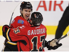 Calgary Flames' Mikael Backlund celebrates with Johnny Gaudreau after scoring in overtime against the Philadelphia Flyers at the Saddledome on Nov. 5, 2015. (Al Charest)