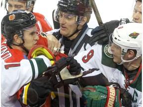 Calgary Flames' Mikael Backlund tussles with Minnesota Wild Mikko Koivu at the Scotiabank Saddledome in Calgary on Dec. 2, 2016. (Mike Drew)