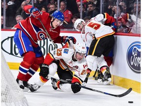 Sean Monahan of the Calgary Flames falls as he tries to play the puck against Jacob De La Rose of the Montreal Canadiens at the Bell Centre on Jan. 24, 2017. (Minas Panagiotakis/Getty Images)