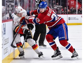 Nathan Beaulieu #28 of the Montreal Canadiens pins Alex Chiasson #39 of the Calgary Flames against the boards during the NHL game at the Bell Centre on January 24, 2017 in Montreal. The Montreal Canadiens defeated the Calgary Flames 5-1.