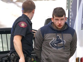 Calgary Police take a man into custody and EMS prepare him for transport to hospital as a precaution on Friday January 27, 2017 in Calgary, Alta after he was arrested for allegedly stealing a car and possible hit and run. Police followed the vehicle from the far southeast and then arrested him after he eventually came to a stop at 46 Ave and Brunswick Ave SW just after the lunch hour. There were reports he allegedly rear-ended a truck on Macleod Tr but there were no injuries.  Jim Wells/Postmedia