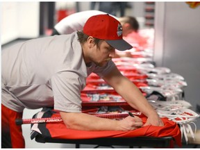 Calgary Roughnecks forward Dane Dobbie signs team jerseys and sticks before practice in Calgary on Thursday, Jan. 5, 2017. They open the 2017 National Lacrosse League regular season at home against the Vancouver Stealth on Friday, Jan. 6 at the Scotiabank Saddledome. (Jim Wells)