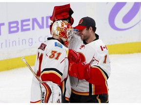 Calgary Flames' Chad Johnson (31) is congratulated by fellow goalie Brian Elliott (1) after the Flames shut out the Minnesota Wild 1-0 on Nov. 15, 2016, in St. Paul, Minn. (AP Photo)