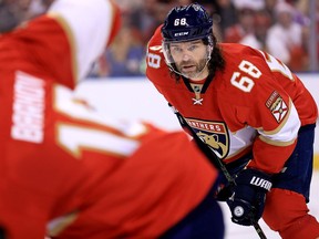 T.J. Brodie of the Calgary Flames tangles with Jaromir Jagr of the Florida Panthers at the Scotiabank Saddledome on Jan. 13, 2016. (Stuart Dryden)