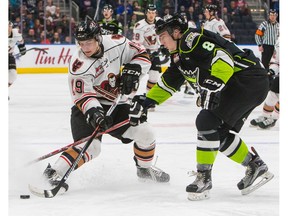 Edmonton Oil Kings Ethan Cap (8) looks for the puck against Calgary Hitmen Radel Fazleev (19) during first period WHL action at Rogers Place, in Edmonton January 1, 2017.