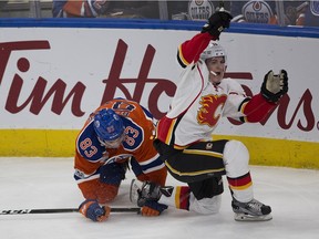 Edmonton Oilers Matthew Benning, left, collides with Calgary Flames Matthew Tkachuk during second period NHL action on January 14, 2017 in Edmonton.