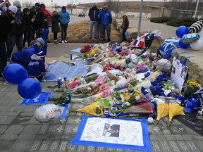 Fans create a memorial for Kansas City Royals baseball pitcher Yordano Ventura outside Kauffman Stadium in Kansas City, Mo., Sunday, Jan. 22, 2017. Ventura died Sunday in a car crash on a stretch of highway near the town of San Adrian in his native Dominican Republic. He was 25.