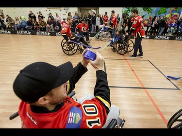 Kris Versteeg of the Calgary Flames bends his stick during an annual wheelchair floor hockey game between the Townsend Tigers and the Flames at the Alberta Children's Hospital in Calgary, Alta., on Tuesday, Jan. 31, 2017. The Townsend Tigers, made up of kids who attend Dr. Gordon Townsend School at the hospital, beat the Flames for the 36th year in a row, this year by a 15-0 score. Lyle Aspinall/Postmedia Network