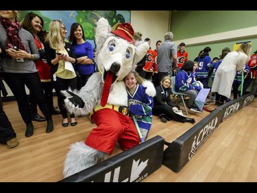 Calgary Flames mascot Harvey the Hound hangs out with Jessica of the Townsend Tigers during an annual wheelchair floor hockey game between the Townsend Tigers and the Flames at the Alberta Children's Hospital in Calgary, Alta., on Tuesday, Jan. 31, 2017. The Townsend Tigers, made up of kids who attend Dr. Gordon Townsend School at the hospital, beat the Flames for the 36th year in a row, this year by a 15-0 score. Lyle Aspinall/Postmedia Network