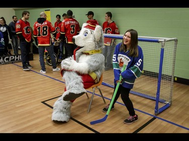 Emily of the Townsend Tigers is helped in net Calgary Flames mascot Harvey the Hound during an annual wheelchair floor hockey game between the Townsend Tigers and the Flames at the Alberta Children's Hospital in Calgary, Alta., on Tuesday, Jan. 31, 2017. The Townsend Tigers, made up of kids who attend Dr. Gordon Townsend School at the hospital, beat the Flames for the 36th year in a row, this year by a 15-0 score. Lyle Aspinall/Postmedia Network