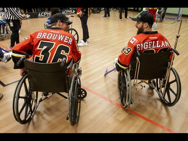 Troy Brouwer and Deryk Engelland of the Calgary Flames have a laugh during an annual wheelchair floor hockey game between the Townsend Tigers and the Flames at the Alberta Children's Hospital in Calgary, Alta., on Tuesday, Jan. 31, 2017. The Townsend Tigers, made up of kids who attend Dr. Gordon Townsend School at the hospital, beat the Flames for the 36th year in a row, this year by a 15-0 score. Lyle Aspinall/Postmedia Network