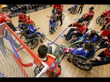 Calgary Flames and Townsend Tigers clash at the net during an annual wheelchair floor hockey game between the Tigers and the Flames at the Alberta Children's Hospital in Calgary, Alta., on Tuesday, Jan. 31, 2017. The Townsend Tigers, made up of kids who attend Dr. Gordon Townsend School at the hospital, beat the Flames for the 36th year in a row, this year by a 15-0 score. Lyle Aspinall/Postmedia Network